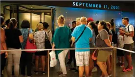  ?? The Associated Press ?? Visitors to the National September 11 Memorial and Museum line up for entrance to the historical exhibition hall in New York.