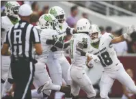  ?? NWA Democrat-Gazette/Charlie Kaijo ?? FAKE OUT: North Texas wide receiver Keegan Brewer (18) celebrates with teammates Saturday after scoring a touchdown on a 90-yard punt return during the Mean Green’s 44-17 victory against the Arkansas Razorbacks at Donald W. Reynolds Razorback Stadium in Fayettevil­le.