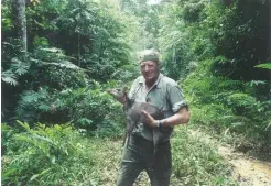  ??  ?? Author with a duiker in the lush rain forest.