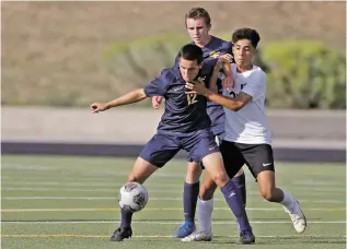  ??  ?? Hope Christian’s Tyler Burks, right, challenges the ball from Santa Fe’s Michael Wissman Jr., left.