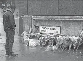  ?? AP/ALBERTO PEZZALI ?? Flowers and pictures are left Sunday in memory of Jack Merritt, who was killed in Friday’s terror attack on London Bridge in London.