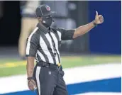  ?? ZACH BOLINGER/AP ?? NFL back judge Grantis Bell signals on the field during a Nov. 29 football game in Indianapol­is.