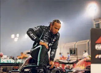  ?? Hamad I Mohammed / Getty Images ?? Lewis Hamilton is subdued as he steps out of his car after winning the crash-marred Bahrain Grand Prix in which Romain Grosjean’s car burst into a fireball after a wreck.