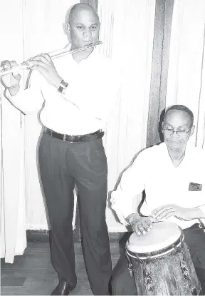  ?? PHOTO BY MICHAEL RECKORD ?? Albert Shaun Hird on flute and Henry Anglin on drums during the JMTC concert.