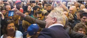  ?? CHRIS YOUNG THE CANADIAN PRESS FILE PHOTO ?? Doug Ford poses for a selfie with a supporter at last year’s Ford Fest in Vaughan in September.