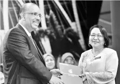  ??  ?? Ali Hamsa presents a letter of appointmen­t to Deputy Director of Aminuddin Baki Institute Mistrine Radin in Putrajaya. — Bernama photo