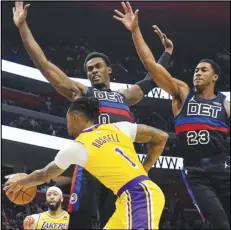  ?? Associated Press ?? Lakers guard D’Angelo Russell (1) passes as Detroit Pistons center Jalen Duren (0) and guard Jaden Ivey (23) defend during the second half, Wednesday, in Detroit.