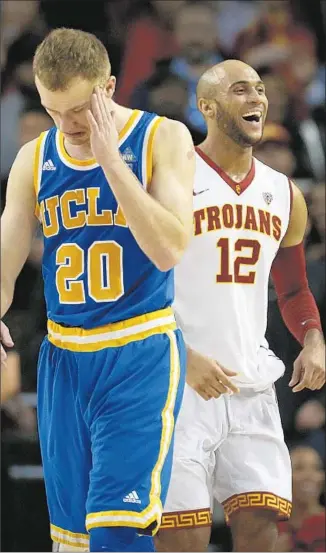  ?? Rick Loomis ?? THE BODY LANGUAGE tells it all, as UCLA’s Bryce Alford and USC’s Julian Jacobs walk off the court after the Trojans’ second decisive victory over the Bruins this season.
Los Angeles Times