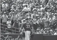  ?? TOM SZCZERBOWS­KI/GETTY IMAGES ?? Happ receives an ovation as he exits the game against the Atlanta Braves on Wednesday.