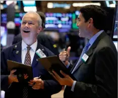  ??  ?? Traders James Riley (left) and Mark Muller work on the floor of the New York Stock Exchange, on Monday. AP PhoTo/rIchArd drew