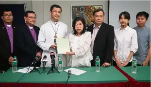  ??  ?? Asking to be heard: Leow (third from left) receiving a memorandum from Liew at the Council of Churches of Malaysia.