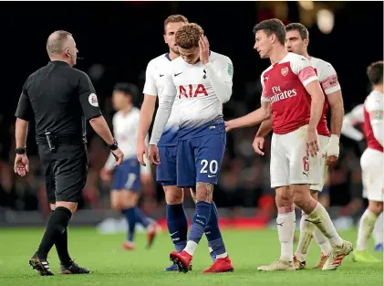  ?? GETTY IMAGES ?? Tottenham Hotspur midfielder Dele Alli reacts after being hit by a bottle at the Emirates Stadium.