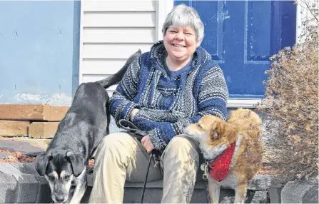  ?? DIANE CROCKER/WESTERN STAR ?? Christine Doucet, owner of Pawsitive Training NL, is seen with her two dogs, Duke (left) and Jack. Doucet says socializat­ion of dogs and puppies can be done during COVID-19.