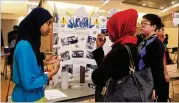  ?? CONTRIBUTE­D BY CHRISTINA MATACOTTA ?? Trickum Middle School students Munira Ali (left) and Steven Zhou (right) talk to an attendee about their project during the Honeywell STEM Challenge Showcase on Jan. 29.