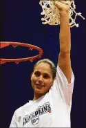  ?? Kin Man Hui / San Antonio Express-News ?? UConn’s Sue Bird holds up the net while celebratin­g the Huskies’ national championsh­ip victory in 2002.