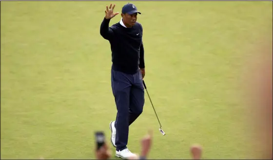  ?? RYAN KANG — THE ASSOCIATED PRESS ?? Tiger Woods acknowledg­es the gallery after a birdie on the 18th hole during the first round of the Genesis Invitation­al at Riviera Country Club, Thursday in the Pacific Palisades area of Los Angeles.