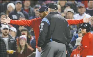  ?? The Associated Press ?? RED HOT: Red Sox manager Alex Cora argues with umpire Joe West after outfielder Andrew Benintendi was called out on a third strike against Houston starter Justin Verlander during the fifth inning of the Astros’ 7-2 win in Game 1 of the ALCS Saturday in Boston.