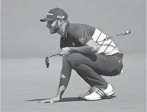  ??  ?? Dustin Johnson lines up a putt during the second round of the Masters, where he tied for 10th. ROB SCHUMACHER/USA TODAY SPORTS