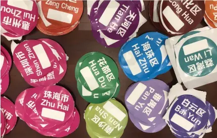  ?? REPORTING ASEAN ?? Guangzhou airport sorting stickers. Passengers are given destinatio­n labels to stick on their clothes.