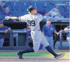  ?? SETH WENIG/ASSOCIATED PRESS ?? Yankees rookie Aaron Judge hits his 50th home run of the season, a seventh-inning blast against the Royals on Monday. He also homered in the third inning.