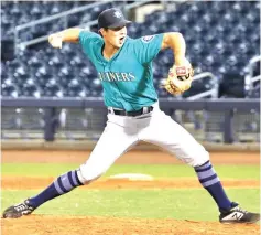  ?? Submitted photo ?? ■ Former Pleasant Grove star player and Dallas Baptist University graduate Jarod Bayless fires a fastball in a minor league game in this undated photo. Bayless was drafted by the Seattle Mariners and is working his way up through the minor league ranks as a pitcher.