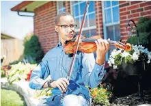 ?? [SARAH PHIPPS/THE OKLAHOMAN] ?? Jaylin Vinson, a Midwest City High School student, plays the violin Thursday at his home in Oklahoma City. Vinson was selected for the Oklahoma Summer Arts Institute's orchestra program in “OSAI at Home.”