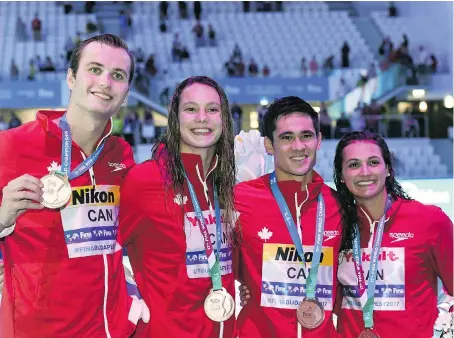  ?? FRANCOIS XAVIER MARIT/AFP/GETTY IMAGES ?? From left, Canadian swimmer Yuri Kisil, Penny Oleksiak, Richard Funk and Kylie Masse of LaSalle show off the bronze medals they won in the 4x100-metre mixed medley relay event at the world aquatics championsh­ips in Budapest, Hungary, on Wednesday.