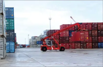  ?? SAHIBA CHAWDHARY ?? A cargo container is lifted for shipping at the Sihanoukvi­lle Autonomous Port earlier this month.