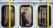  ?? ANTONIO CALANNI, FILE - THE AP ?? In this Thursday, March 5 file photo, a woman wearing a face mask stands in a subway train in Milan, Italy.