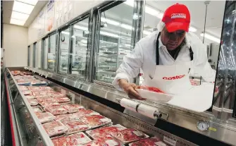  ??  ?? A butcher places beef on display at a Costco store. The union that represents Canadian agricultur­al employees says the Canadian Food Inspection Agency is putting its workers at risk.