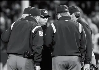  ?? ASSOCIATED PRESS ?? THIS OCT. 19, 2010, FILE PHOTO shows umpires huddling after an apparent home run by New York Yankees’ Lance Berkman in the second inning of Game 4 of baseball’s American League Championsh­ip Series against the Texas Rangers in New York.