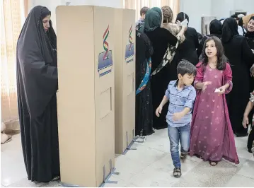  ?? CHRIS MCGRATH / GETTY IMAGES ?? People cast their referendum votes Monday at a voting station in Irbil despite strong objection from neighbouri­ng countries and the Iraqi government. Some five million Kurds took to the polls in the referendum.