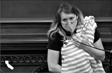  ?? California State Assembly via AP ?? In this still image from California State Assembly video, Assemblywo­man Buffy Wicks, a Democrat from Oakland, addresses lawmakers on a housing bill while holding her one-month-old daughter Elly in her arms during the final hours of the California legislativ­e session on Monday in Sacramento, Calif.