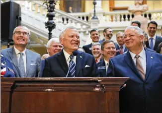  ?? BOB ANDRES / BANDRES@AJC.COM ?? Gov. Nathan Deal, flanked by Lt. Gov. Casey Cagle (left) and House Speaker David Ralson, announced Tuesday a compromise plan for dealing with the state windfall created by the federal tax law, calling for a reduction in state income tax rate and an...