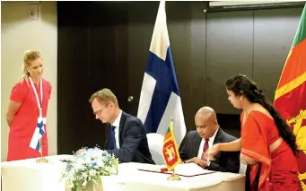  ??  ?? Deputy Minister of Economic Affairs & Employment, Petri Peltonen and education ministry secretary Sunil Hetiarachc­hi sign the agreement