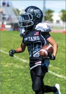  ??  ?? El Centro Trojans’ Francisco Teruel runs the ball during a home American Youth Football game against the Lake Havasu Chiefs on Saturday afternoon in El Centro.