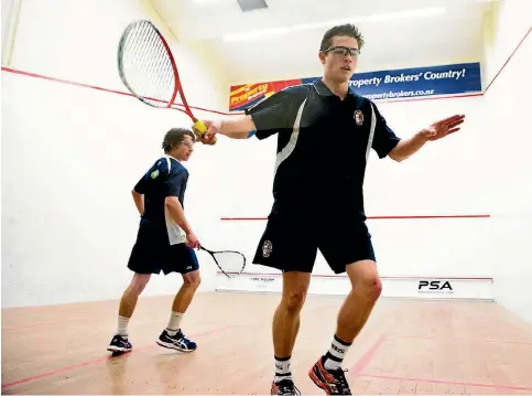  ?? PHOTO: WARWICK SMITH/STUFF ?? Palmerston North Boys’ High School’s Jordan Bell, front, taking on Jack Niles from Tauranga Boys’ College on finals day at the national secondary schools squash at Squashgym Palmerston North on Sunday.