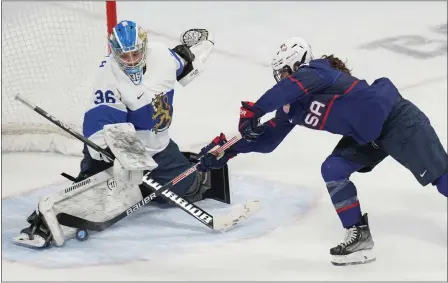  ?? PHOTOS: PETR DAVID JOSEK — THE ASSOCIATED PRESS ?? Finland goalkeeper Anni Keisala blocks a shot by the United States' Kelly Pannek during a semifinal game on Monday in Beijing.