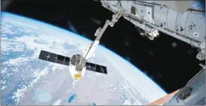  ?? NASA/AFP ?? This NASA image taken on April 17, 2015, shows the Canadarm 2 reaching out to grapple a cargo spacecraft on the Internatio­nal Space Station.