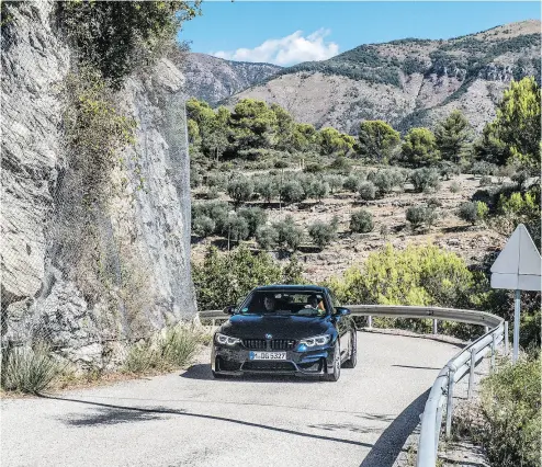  ?? LUCAS SCARFONE / BMW ?? A brand-new BMW M6 Coupe handles a tight turn as it climbs the highway on the way to Monte Carlo .