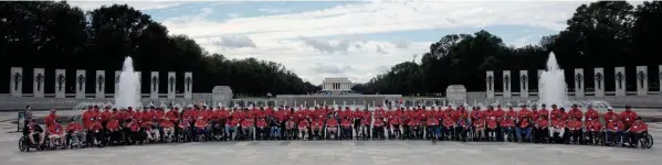  ?? PHOTOS BY NICOLAS GALINDO/COLUMBUS DISPATCH ?? One hundred, twenty-seven veterans from the Korean War, Vietnam War and one from World War II pose for a photo at the World War II Memorial in Washington, D.C., during Honor Flight Columbus Mission #104 on Thursday. Honor Flights began in 2005 to bring surviving World War II veterans to Washington to visit the World War II memorial after it was completed in 2004.