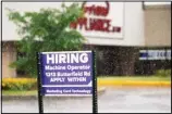  ??  ?? A hiring sign shows in Downers Grove, Illinois, Thursday, June 24, 2021. Pay is going up across many industries as the economy roars out of the recession. (AP)