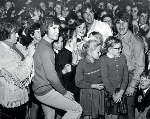  ?? AUCKLAND STAR ?? Larry’s Rebels in October 1968. From left, Drummer Nooky Stott (giving an autograph), bass player Viv McCarthy (head visible at rear), lead guitarist John Williams, organist Mal Logan (in white shirt), and Larry Morris.