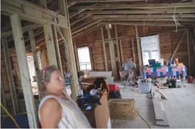  ?? AP PHOTO/REBECCA BLACKWELL ?? On Wednesday, Jacquelyn and Timothy Velazquez sit inside the gutted shell of their 910-square-foot, two-bedroom home, which was damaged when Hurricane Ian’s storm surge rose to within inches of the ceiling, in Fort Myers Beach, Fla.