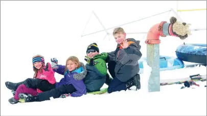  ?? Ernest A. Brown photo ?? Sophie Boisvert, 8, Ella Boisvert, 9, Owen Boisvert, 11, and Jack Boisvert, also 11, cousins of North Smithfield, from left, enjoy a snow day sledding at the hills at the North Smithfield High School Athletic Fields on Thursday. The heavy, wet snow...