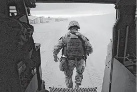  ??  ?? A solider steps out of a military vehicle at the airfield. Reinforcem­ents have paved the way for Iraqi forces to lead the offensive while U.S. soldiers advise.