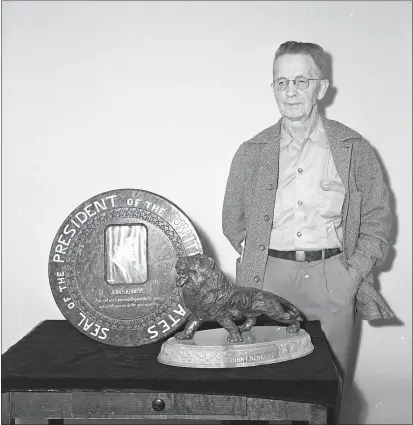  ?? TIMES-STANDARD FILE PHOTO ?? Henry F. Osterblom stands by the lion sculpture and presidenti­al seal he carved to honor the late President John F. Kennedy. The pieces were completed in November 1964.