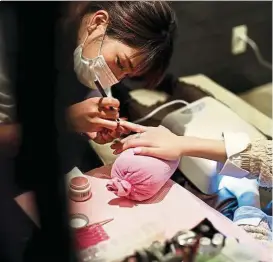 ??  ?? A stylist manicures nails of a Japanese customer at a nail saloon in Tokyo. Nail art is taking off in the United States and is already popular in China and South Korea. But beauty-conscious Japan is ground-zero for the business. — AFP
