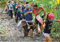  ?? LUIS ACOSTA AFP VIA GETTY IMAGES ?? Venezuelan migrants reach a village in Panama near the Darién Gap, one of the world’s most dangerous migration routes.