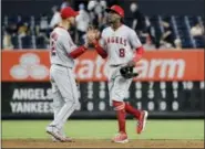  ?? FRANK FRANKLIN II - THE ASSOCIATED PRESS ?? Los Angeles Angels’ Cameron Maybin (9) celebrates with Andrelton Simmons (2) after the Angels defeated the New York Yankees 8-3 in a baseball game Tuesday, in New York.